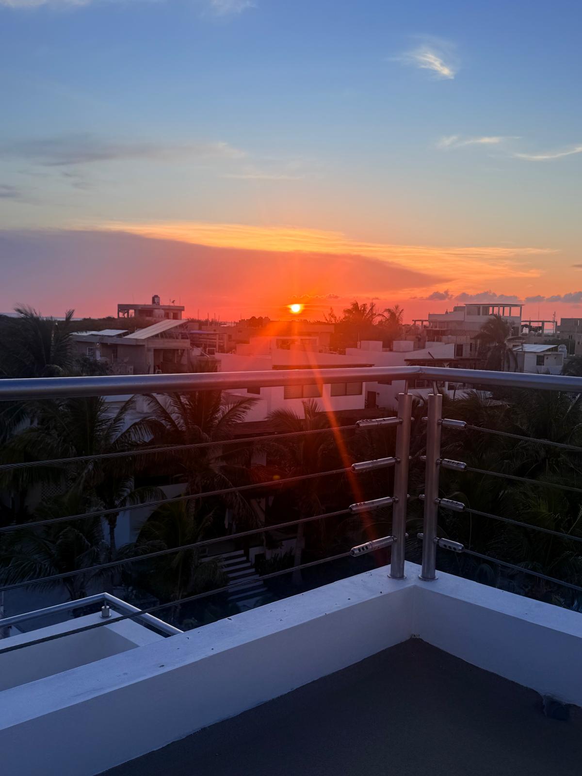 Sunset from the rooftop terrace railing