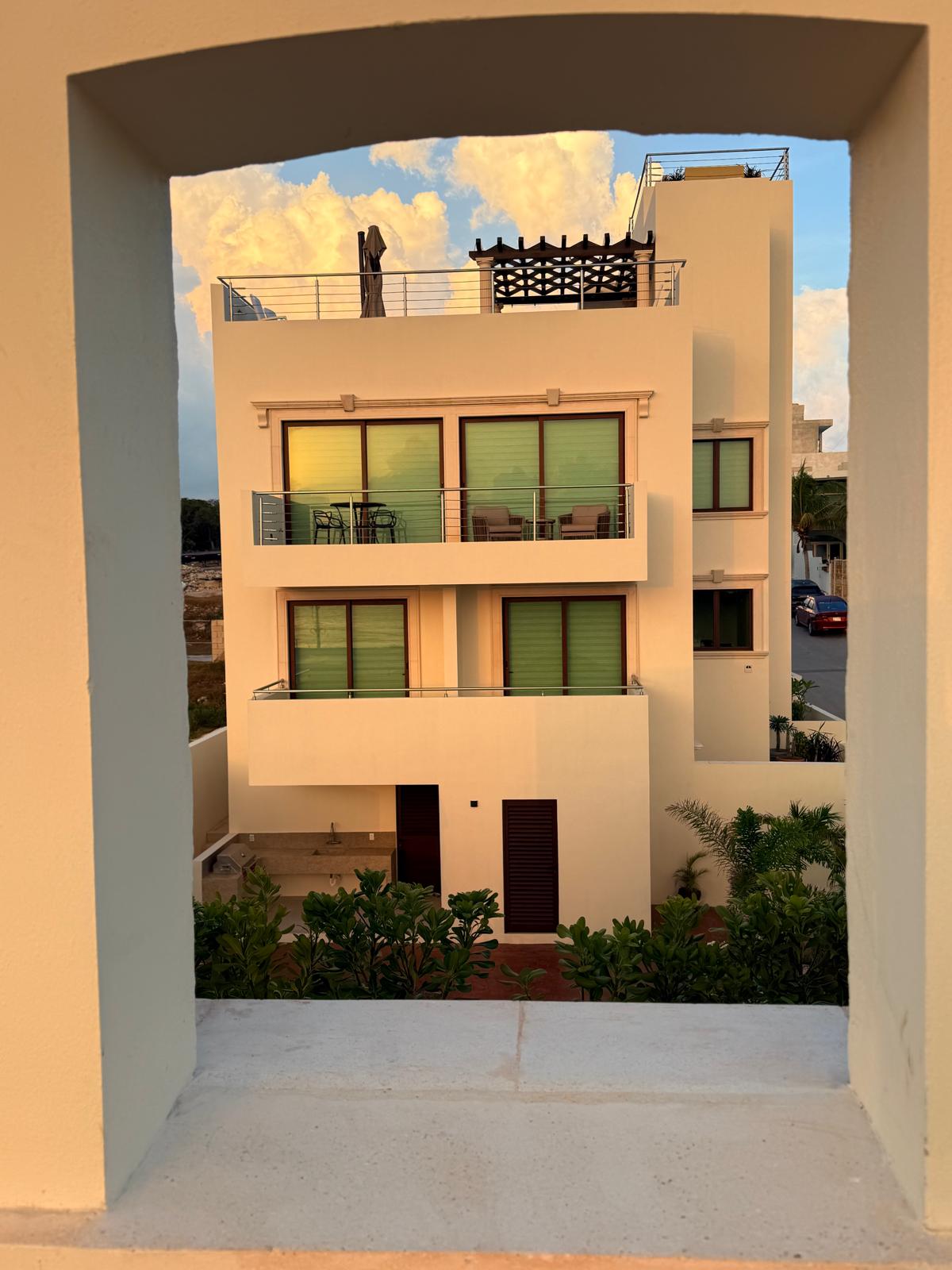 Estate building framed by an arched terrace window opening