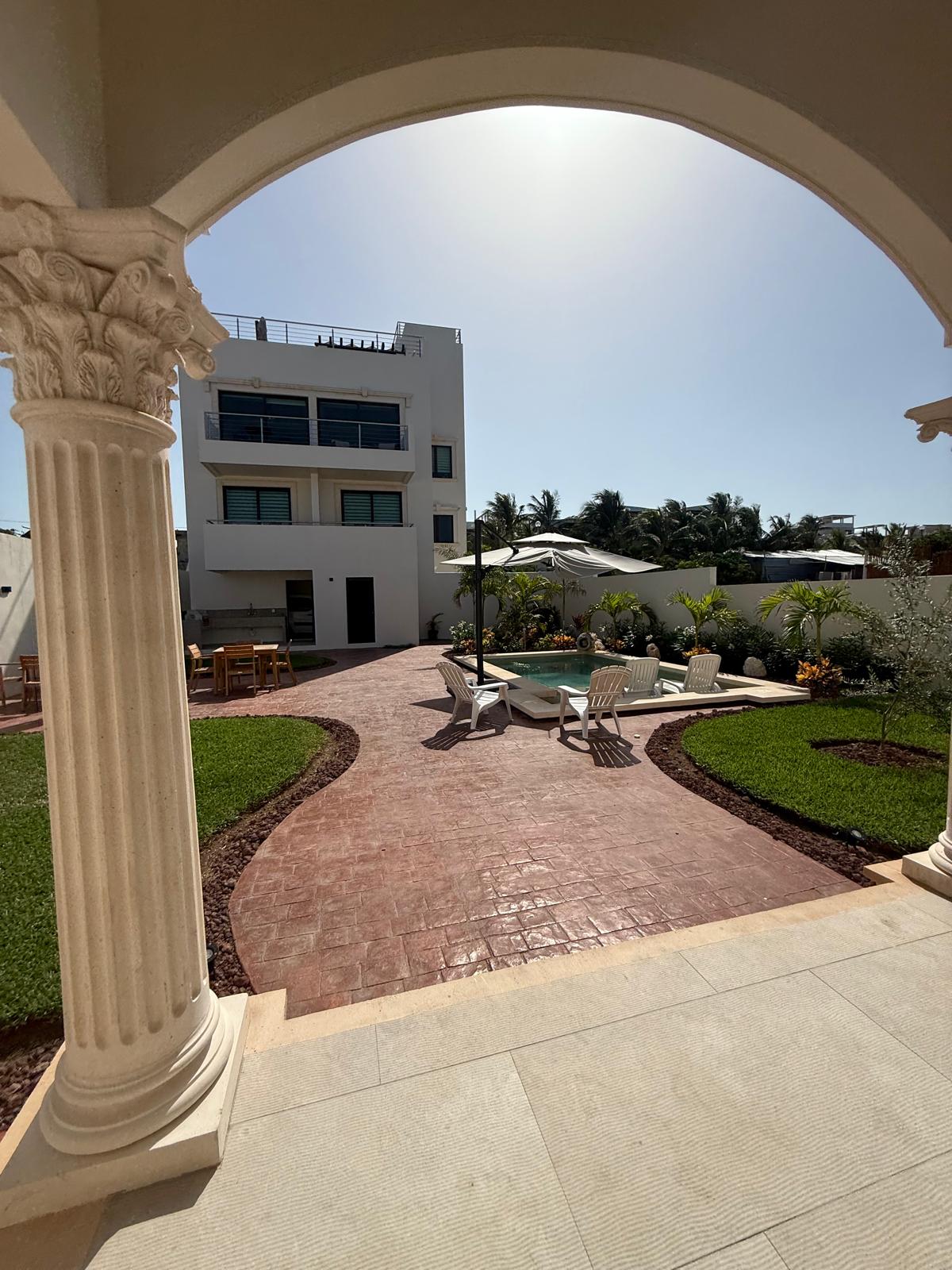 View through the archway to the courtyard pool and Casa Isola