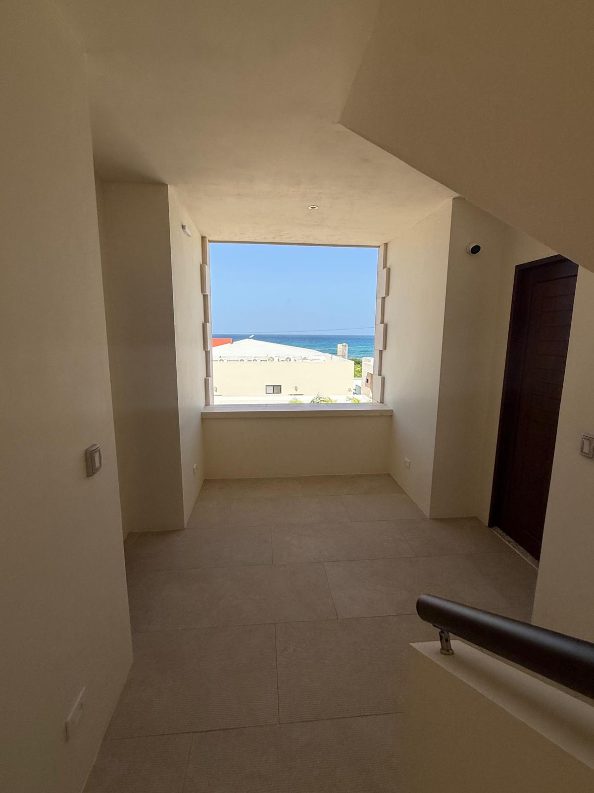 Upper landing with a picture window framing the sea