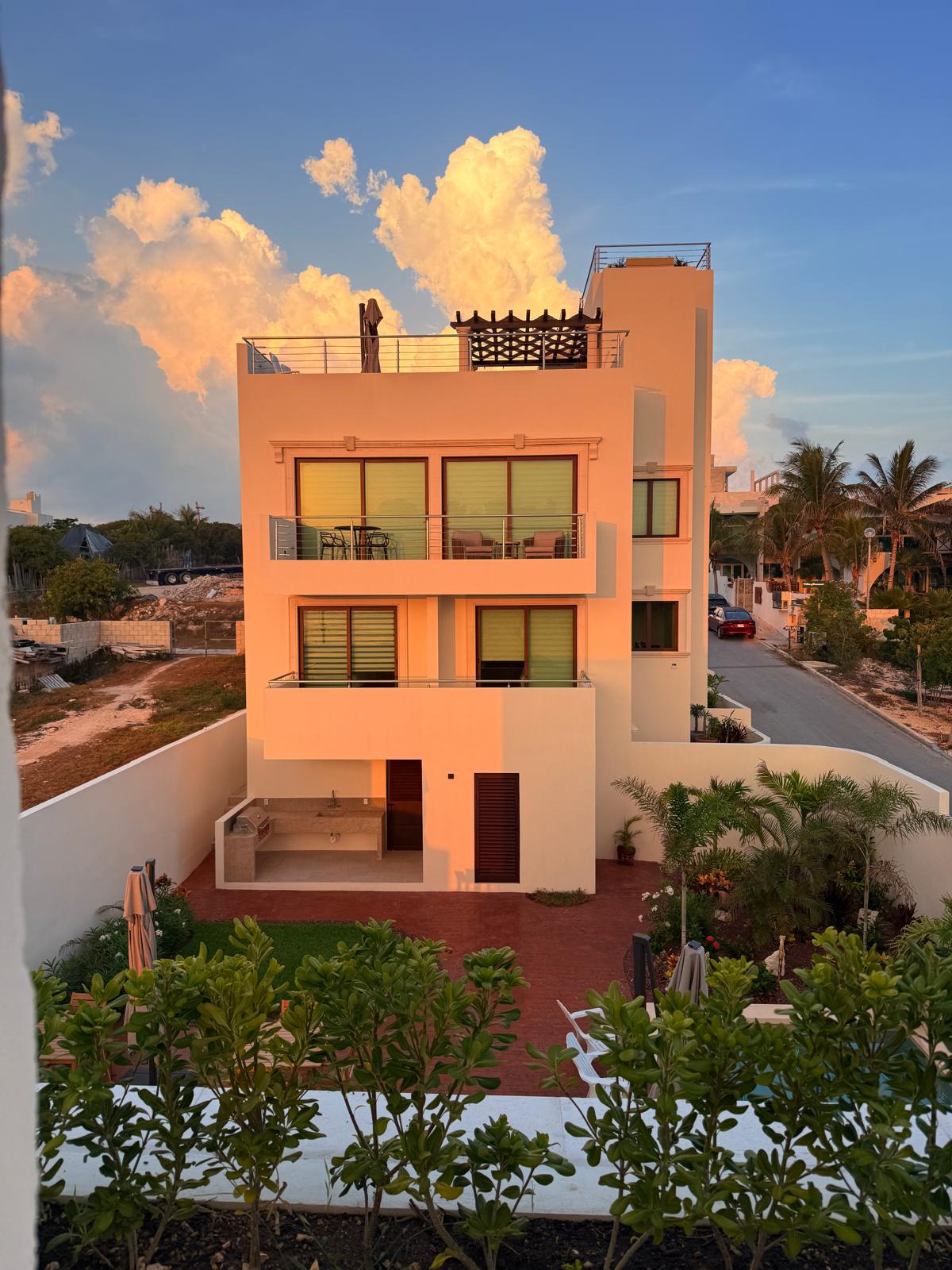 Estate facade and courtyard garden glowing at golden hour