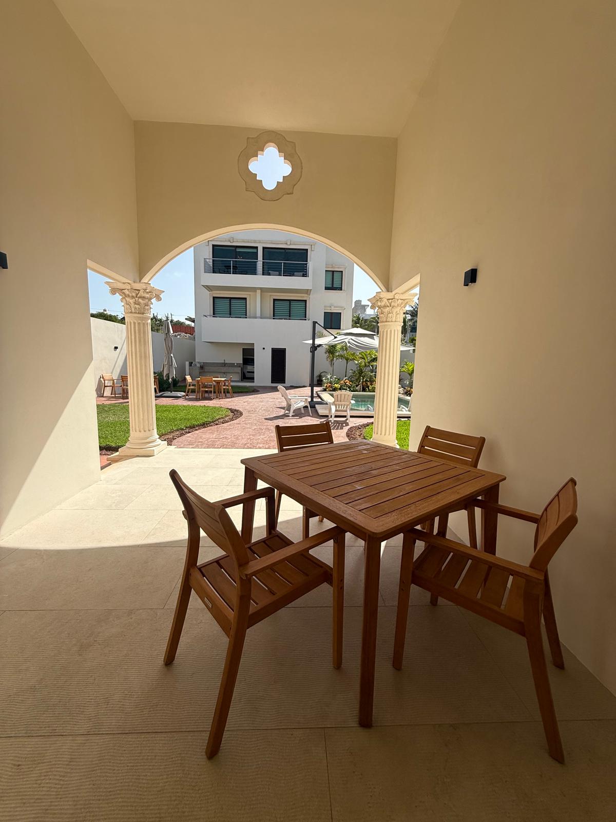 Covered terrace dining table under the arched colonnade