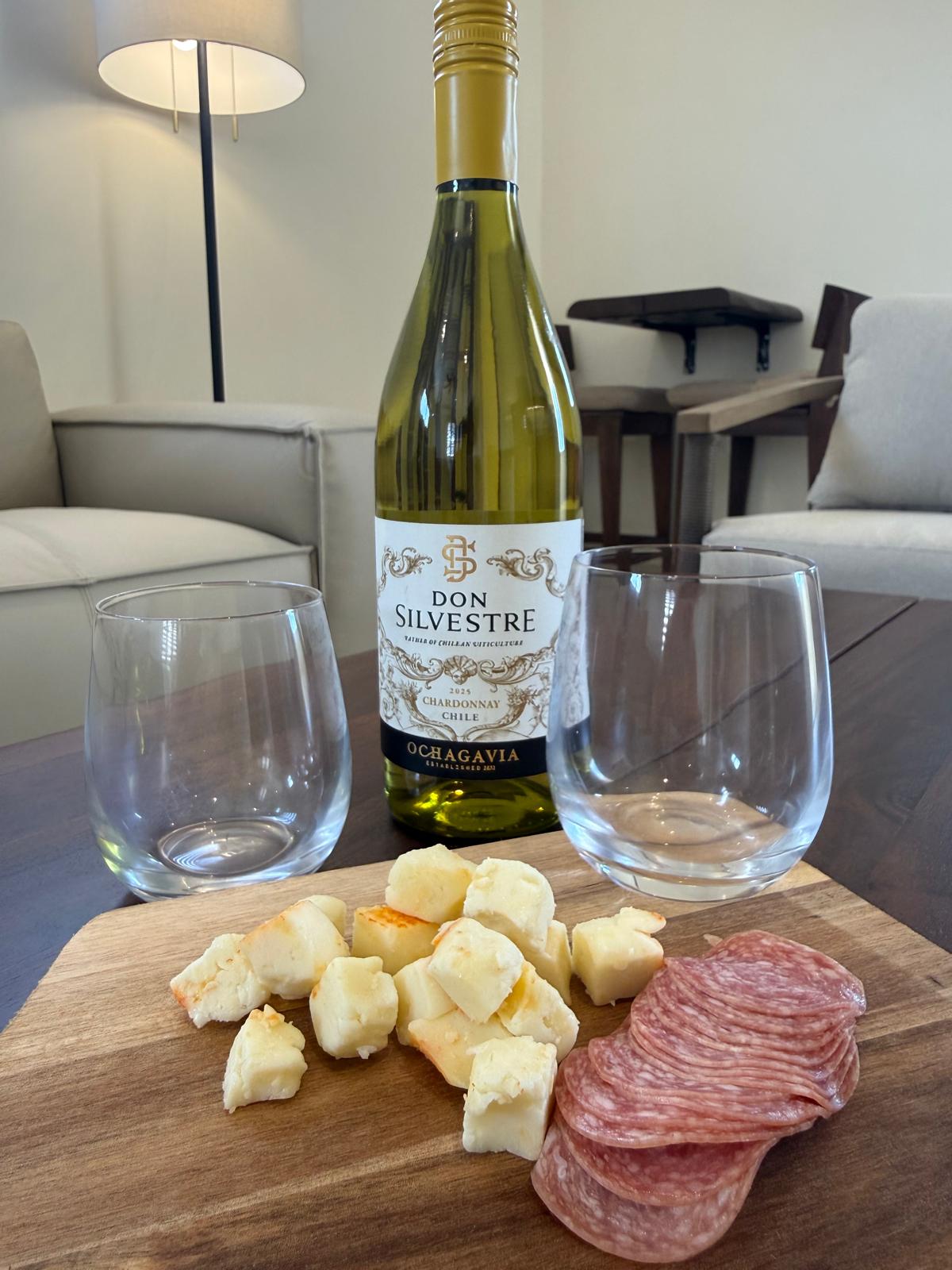 Chilled Chardonnay with cheese and salami board in a suite living room
