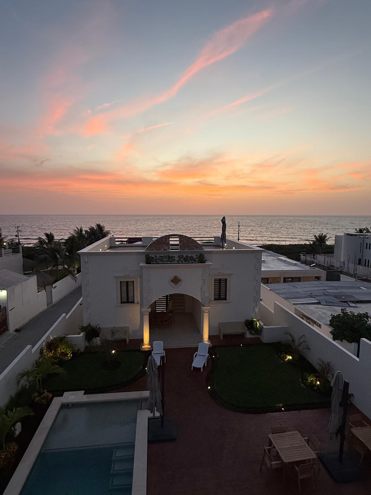 Aerial view of the estate courtyard and Caribbean Sea at sunset