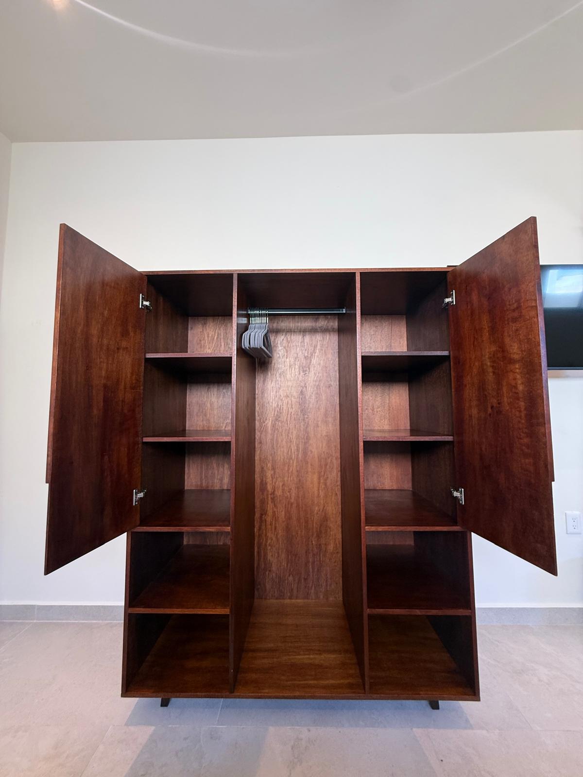 Mahogany wardrobe with open doors and hanging space