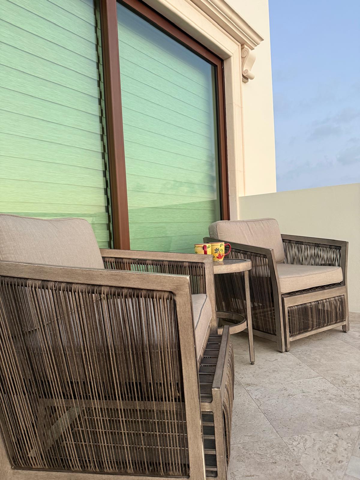 Rooftop terrace lounge chairs beside the suite windows