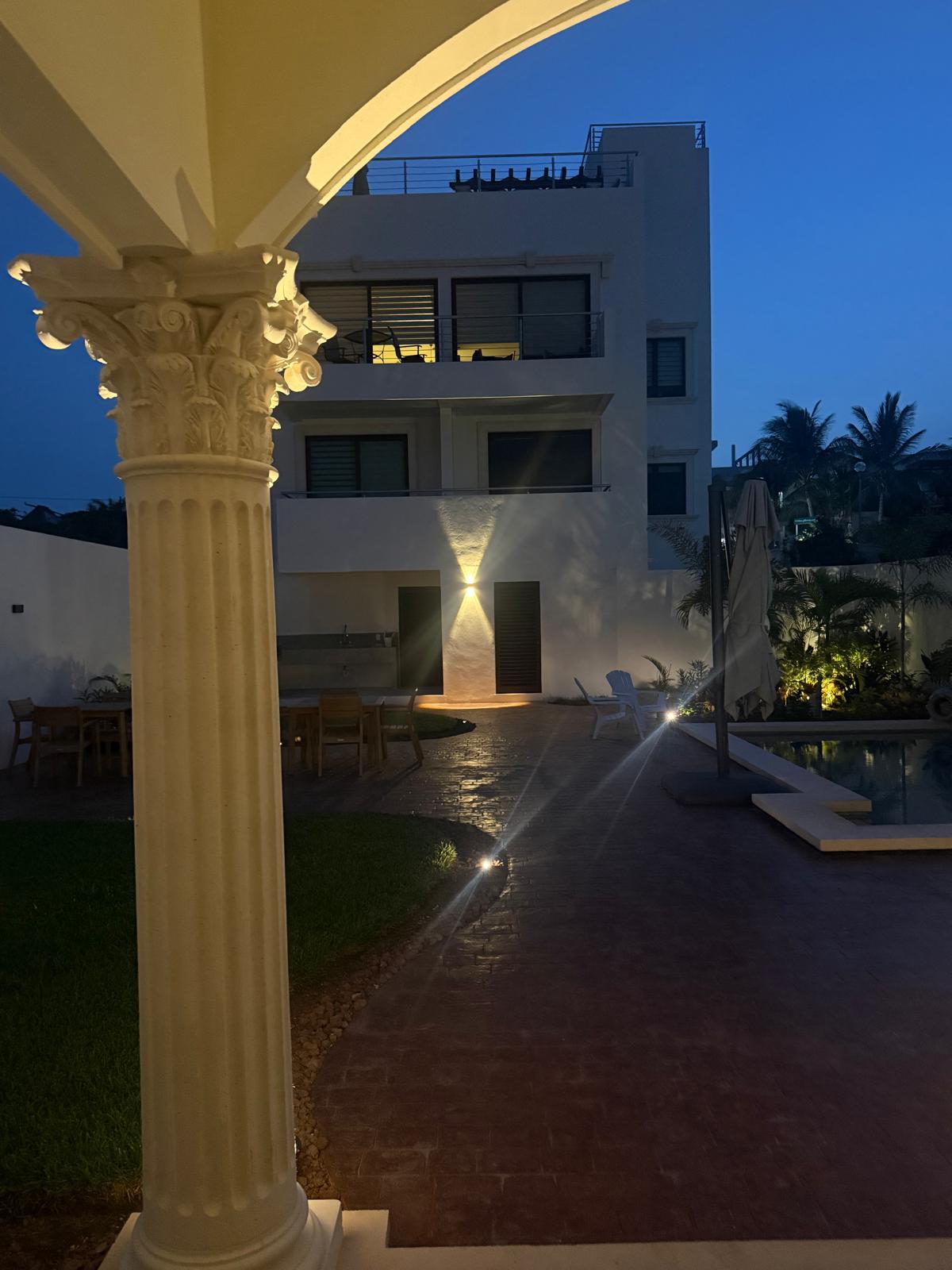 Corinthian column framing the illuminated courtyard at blue hour