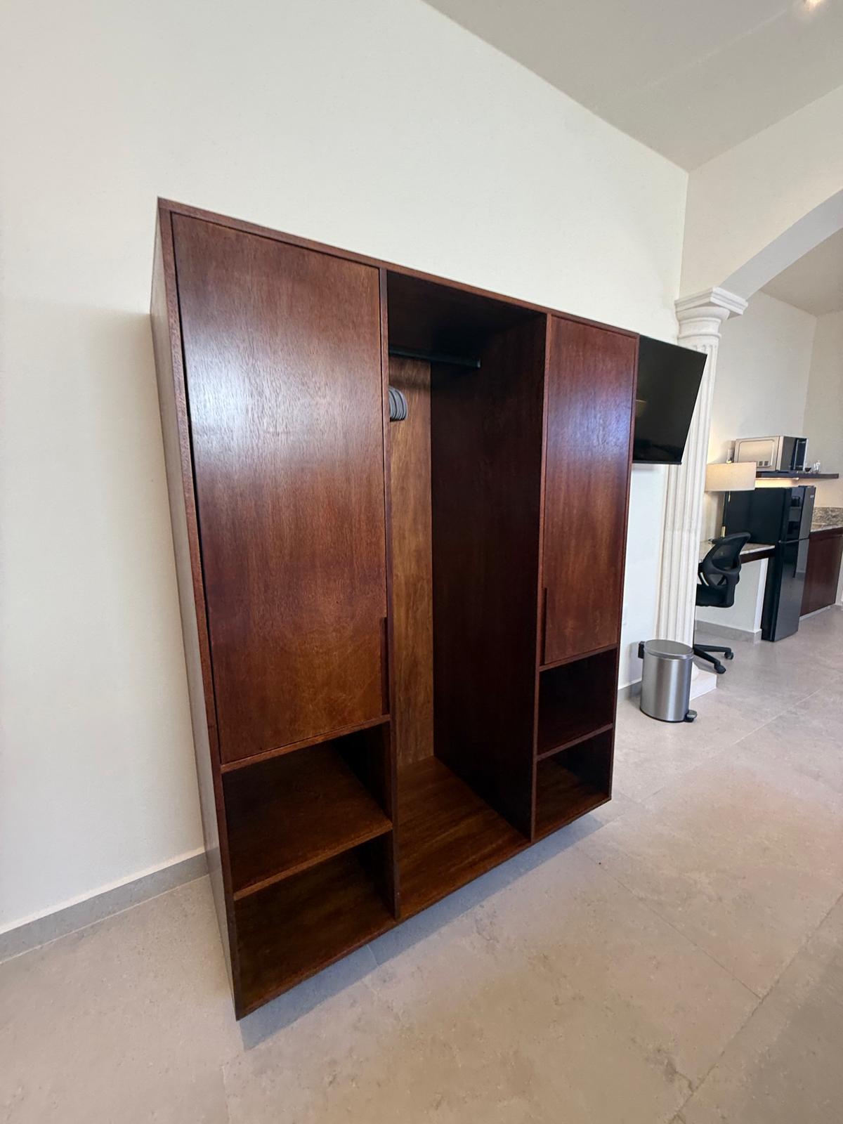Custom hardwood closet beside the kitchenette