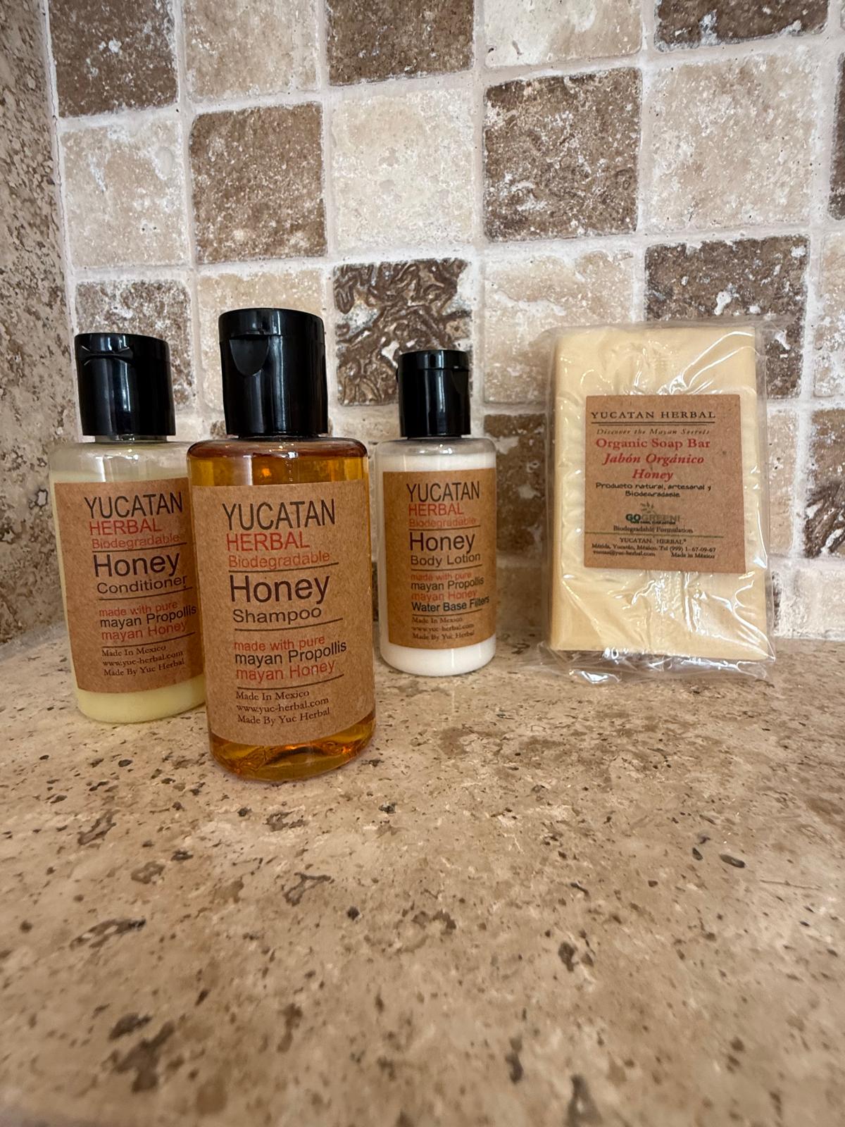 Yucatan Herbal honey bath amenities on a stone counter