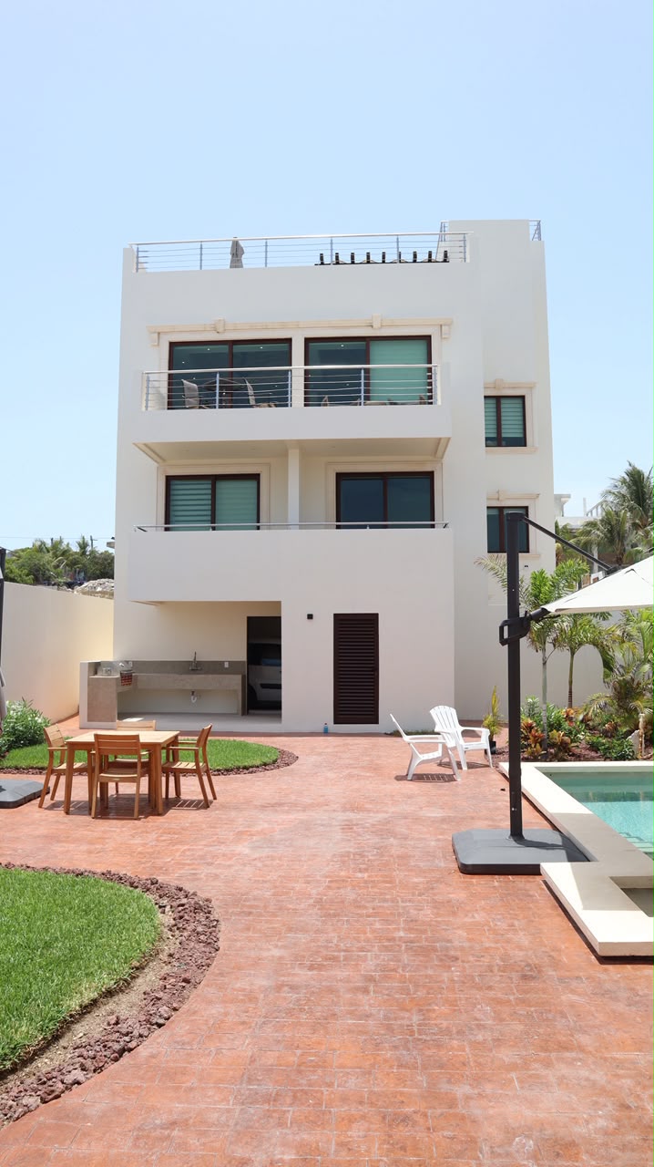 Rear facade of the estate with balconies and courtyard pool