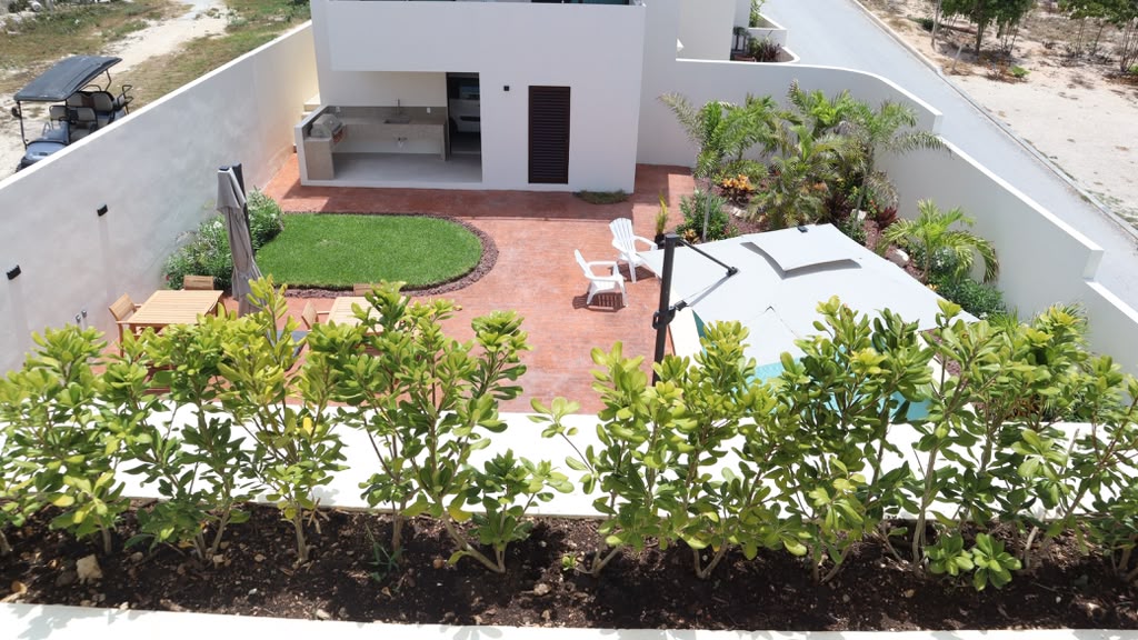 Courtyard garden, outdoor kitchen, and pool from above