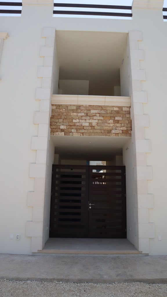 Stone-framed entry with iron gates