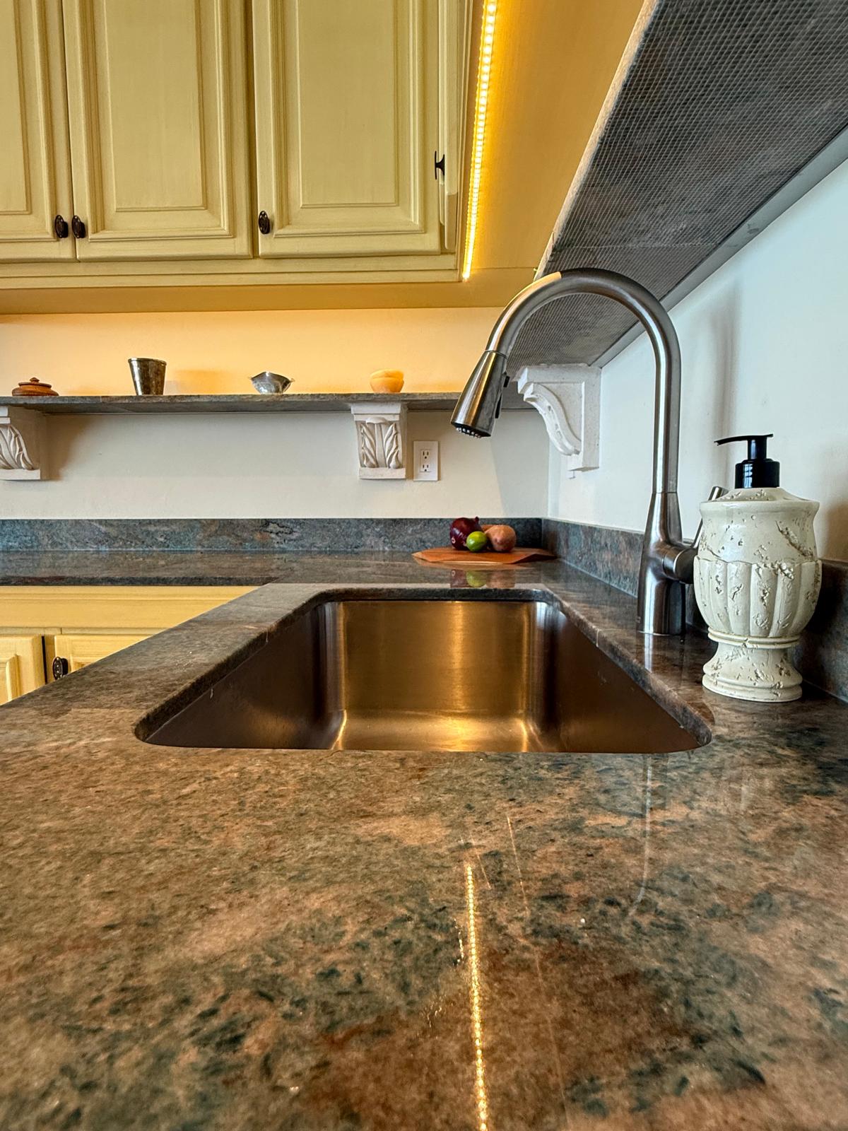 Granite kitchen counter with undermount sink and pull-down faucet