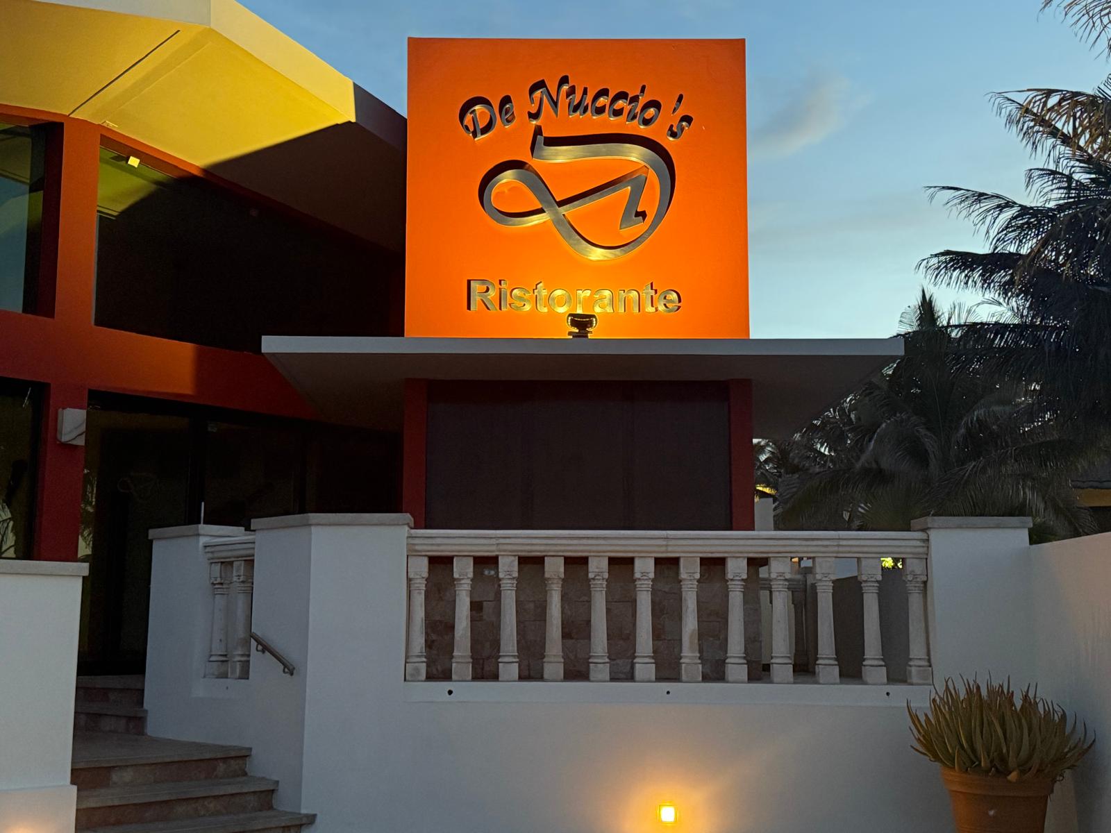 Illuminated De Nuccio's Ristorante sign above the entrance stairs