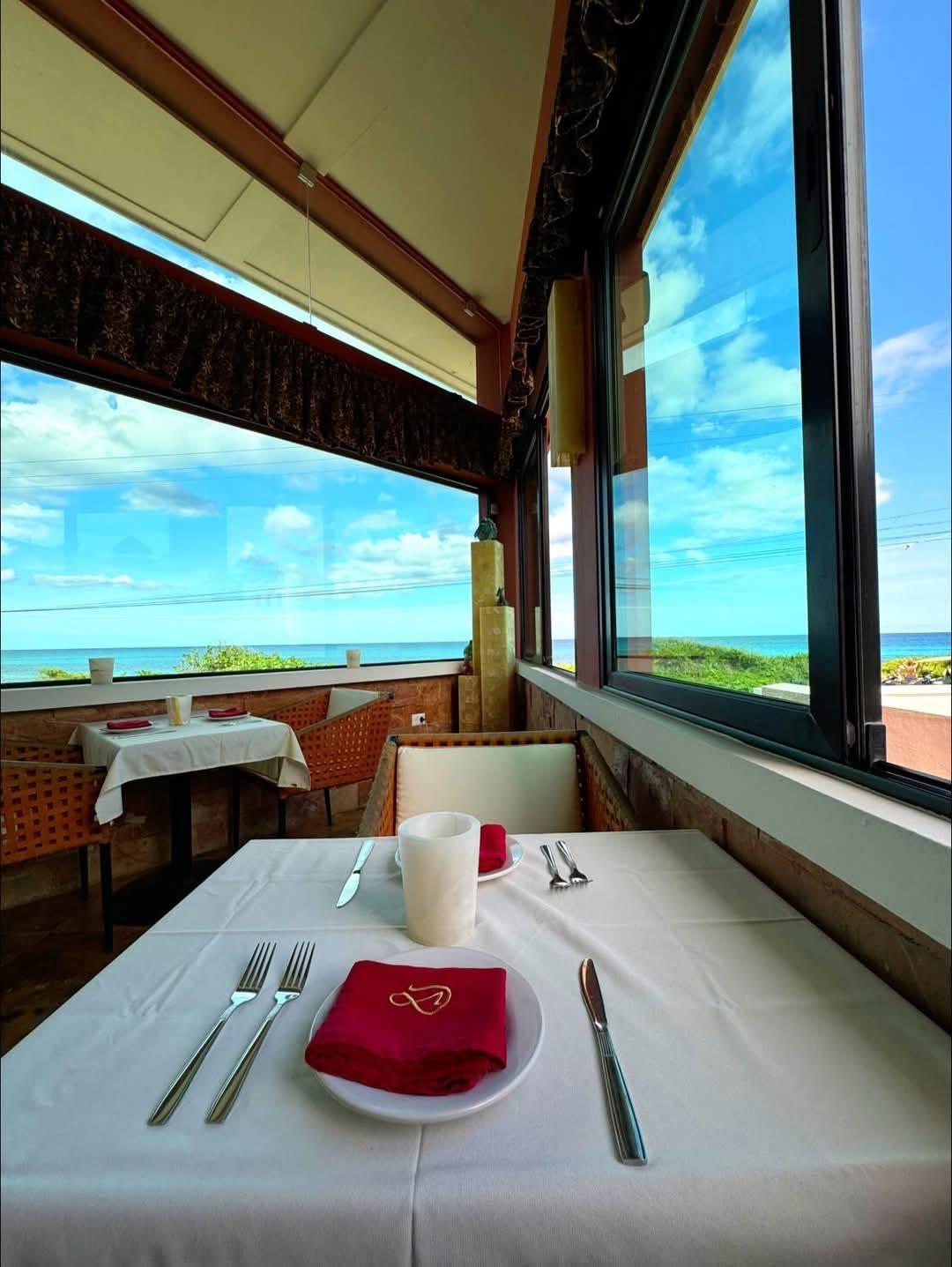 Window-side table set for two above the sea