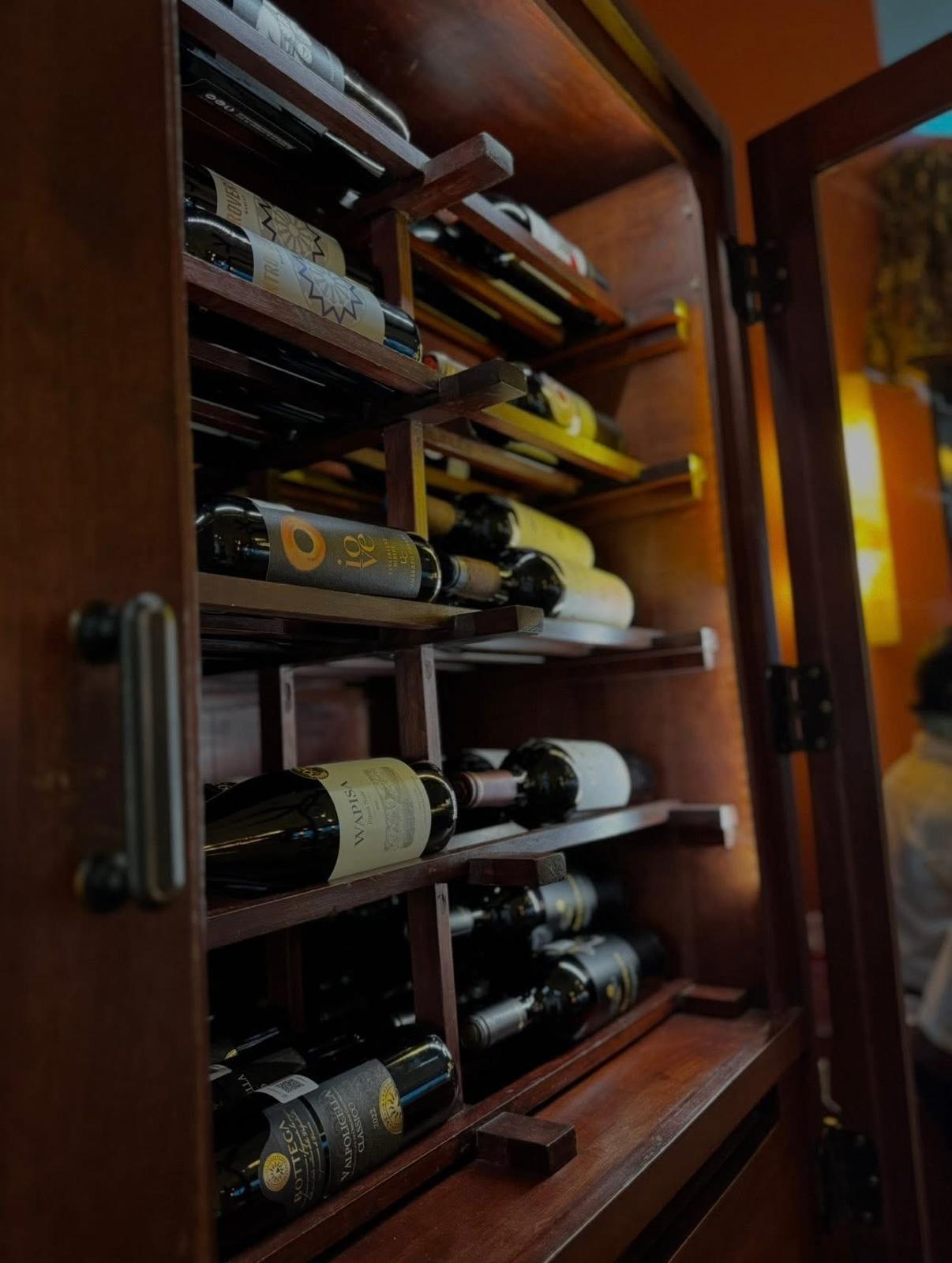 Wine cabinet stocked with Italian bottles
