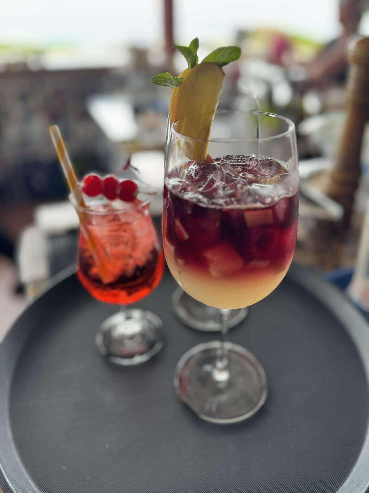 Sangria and a berry spritz served on a tray