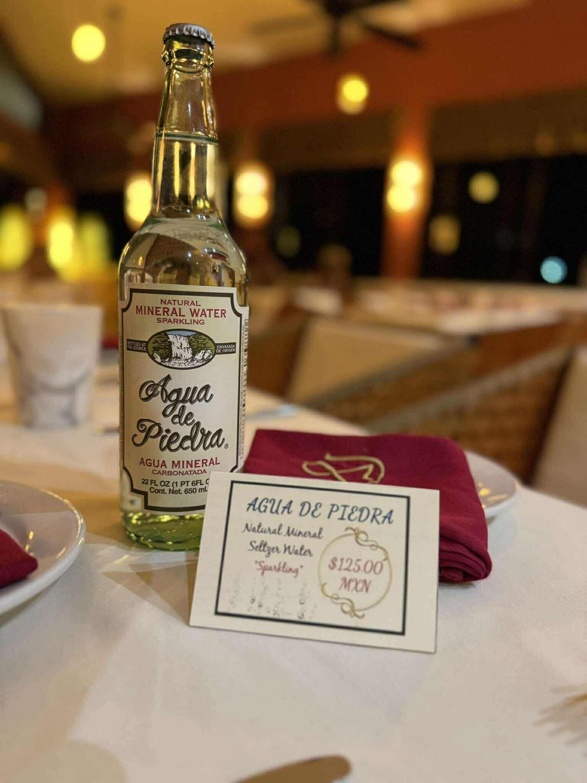 Bottle of Agua de Piedra sparkling mineral water on a set table