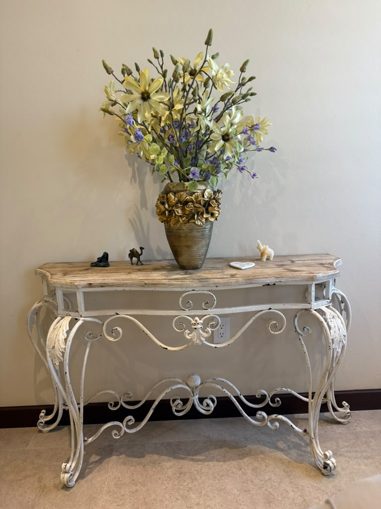 Vintage console table with floral arrangement