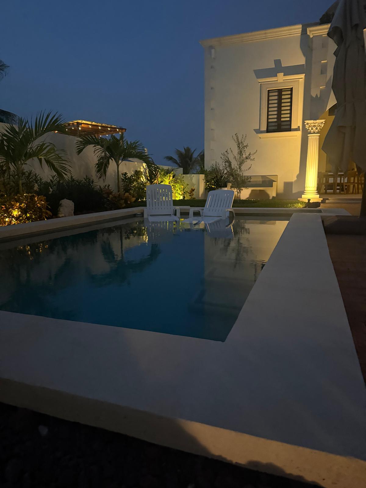 Courtyard pool mirroring the estate at dusk